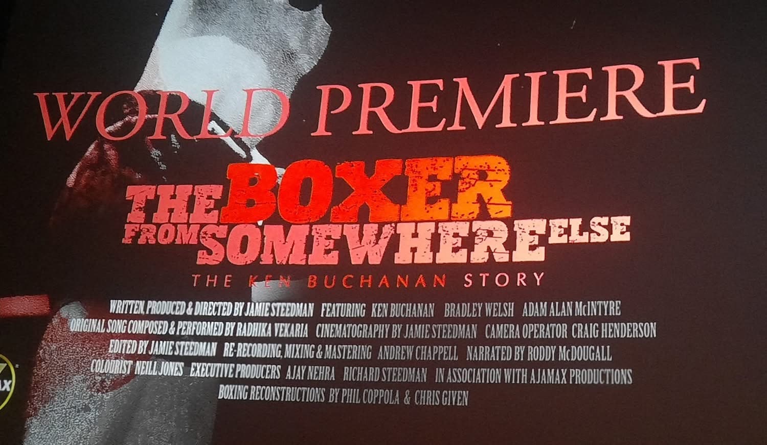 The title card on the cinema screen: World Premiere, The Boxer from Somewhere Else