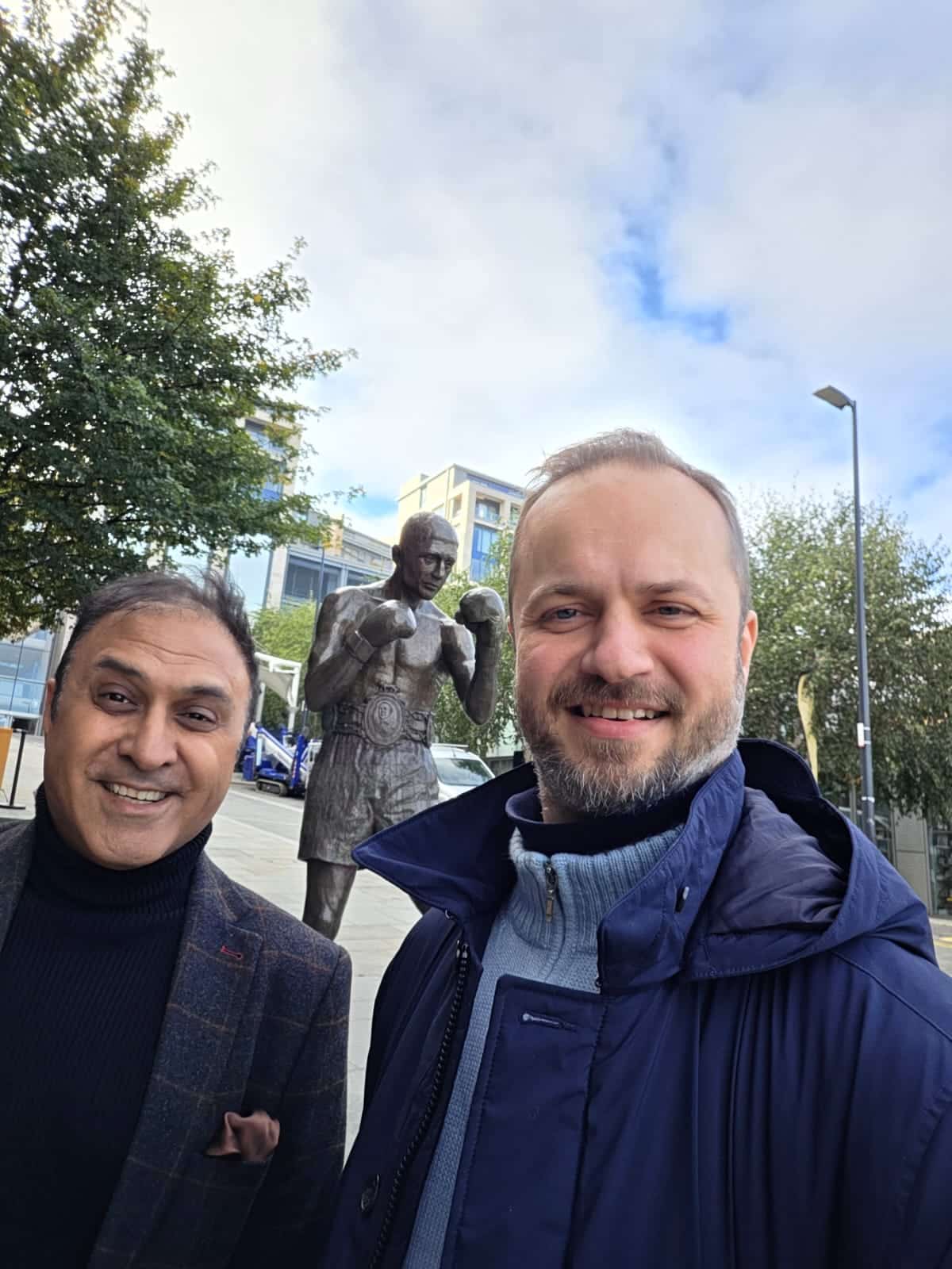 Ajay Nehra and Jamie Steedman beside a statue outside the cinema