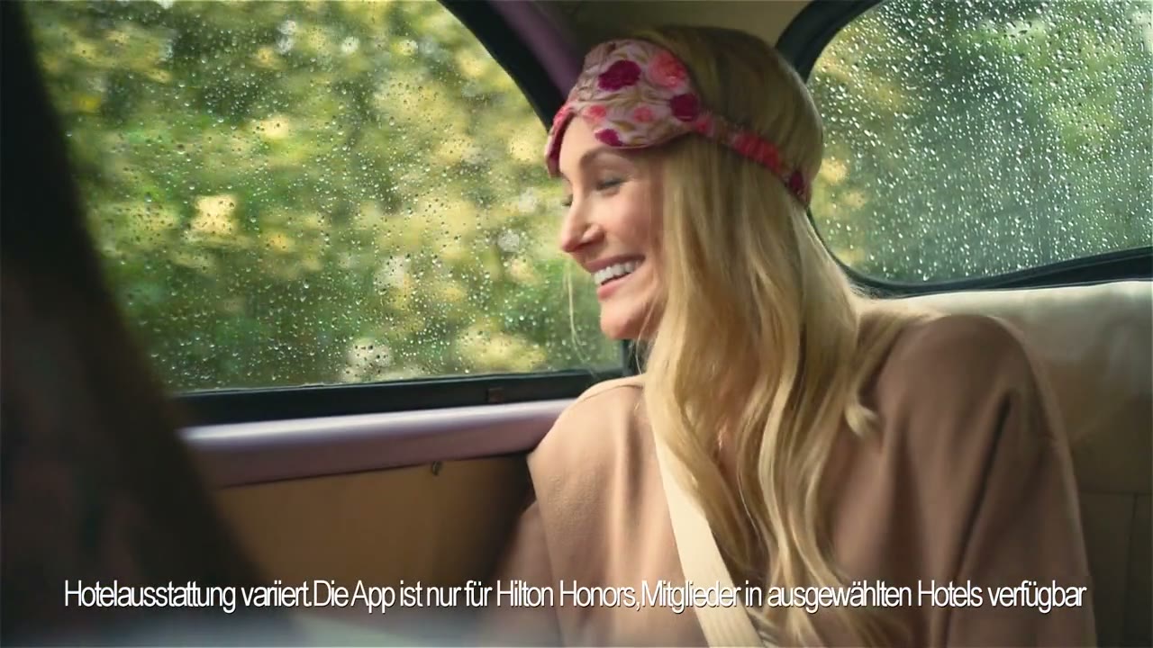 Play the Hilton Fresh Start film: a woman smiling from a car window